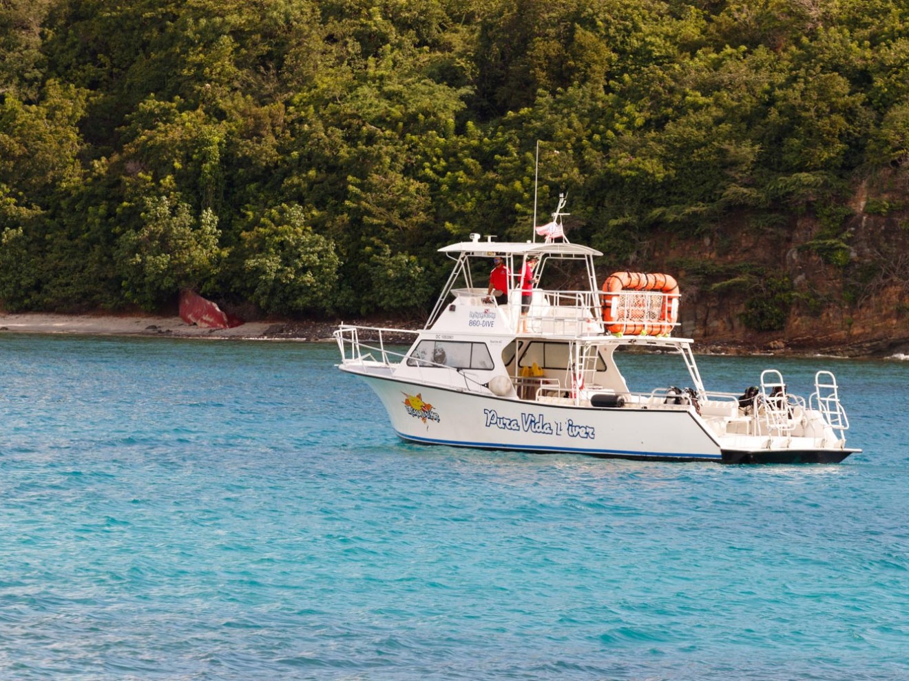 pura vida boat in water 2