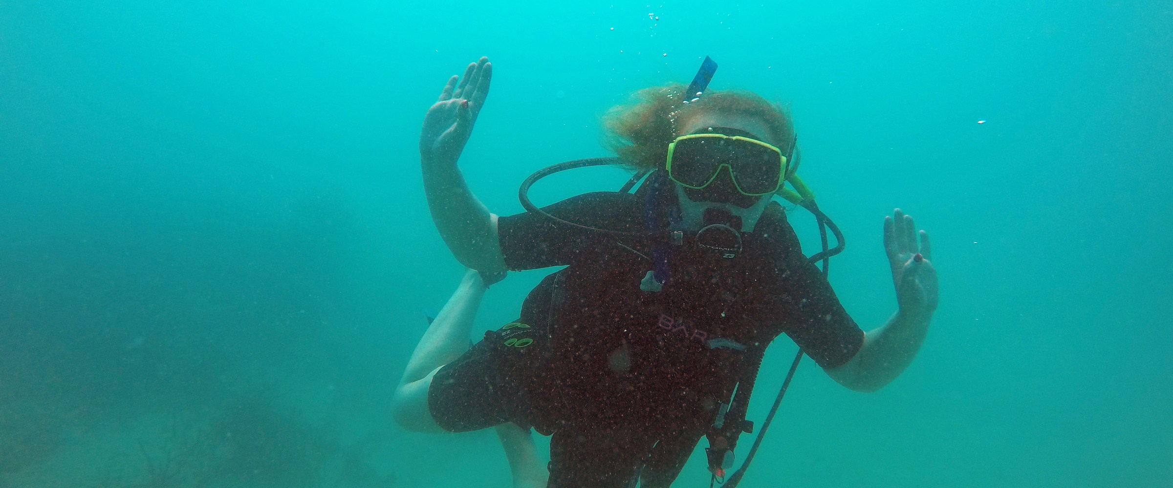 Scuba diver dancing in ocean