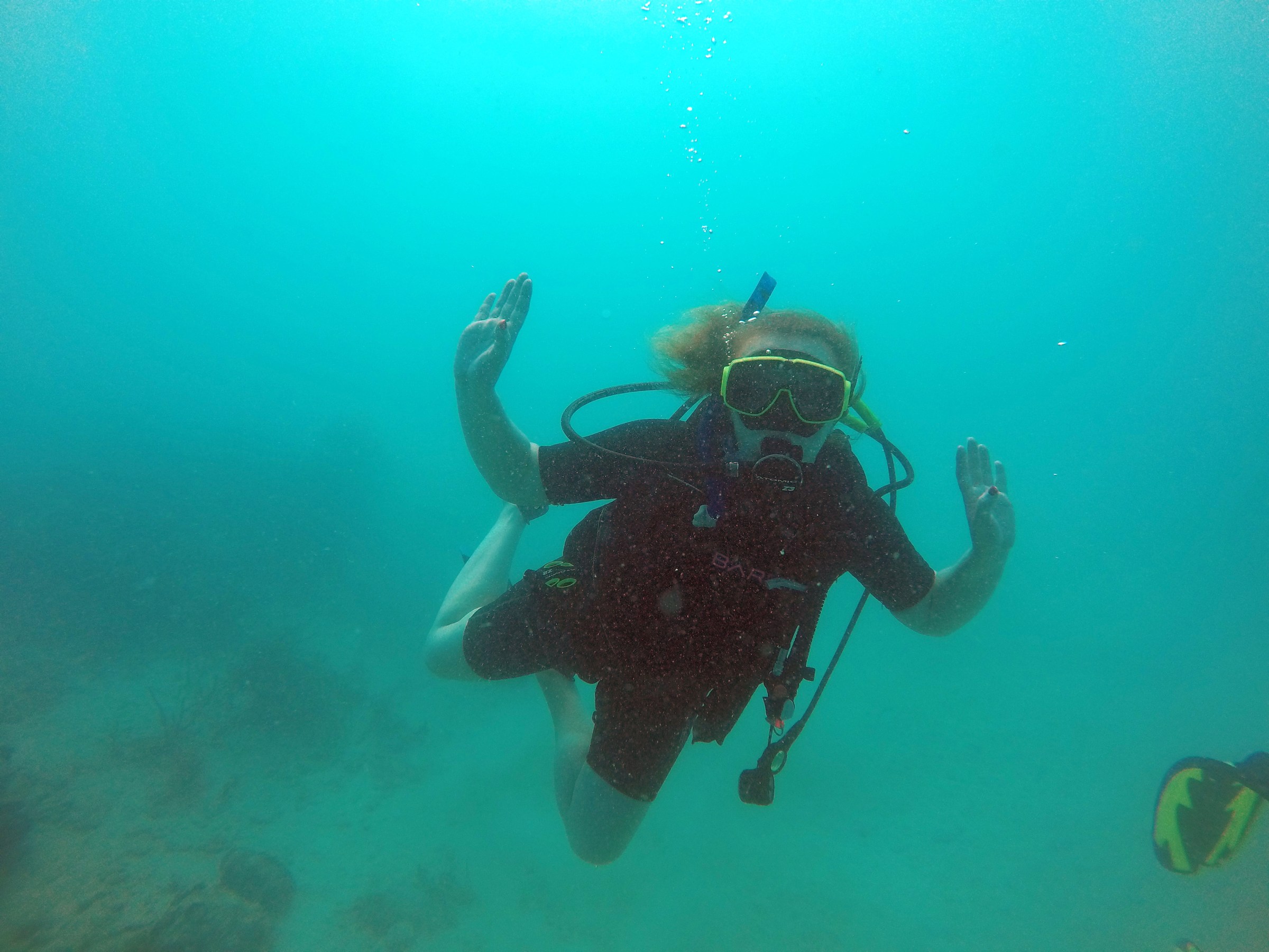 Scuba diver dancing in ocean