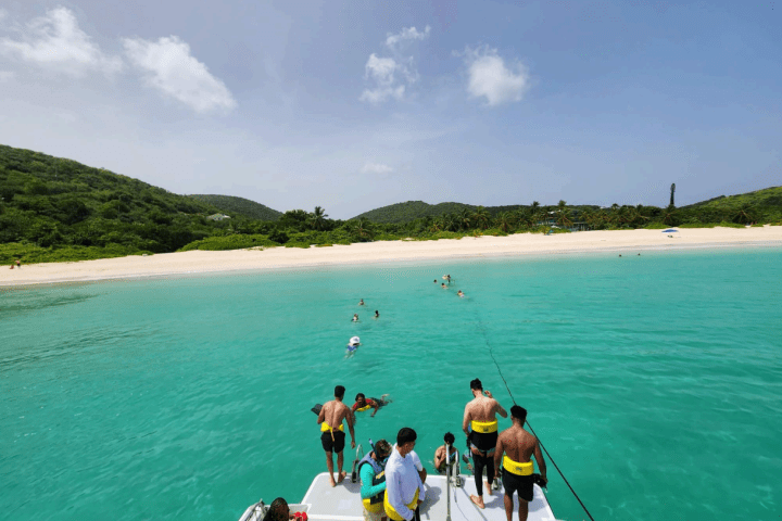 a group of people standing next to a body of water
