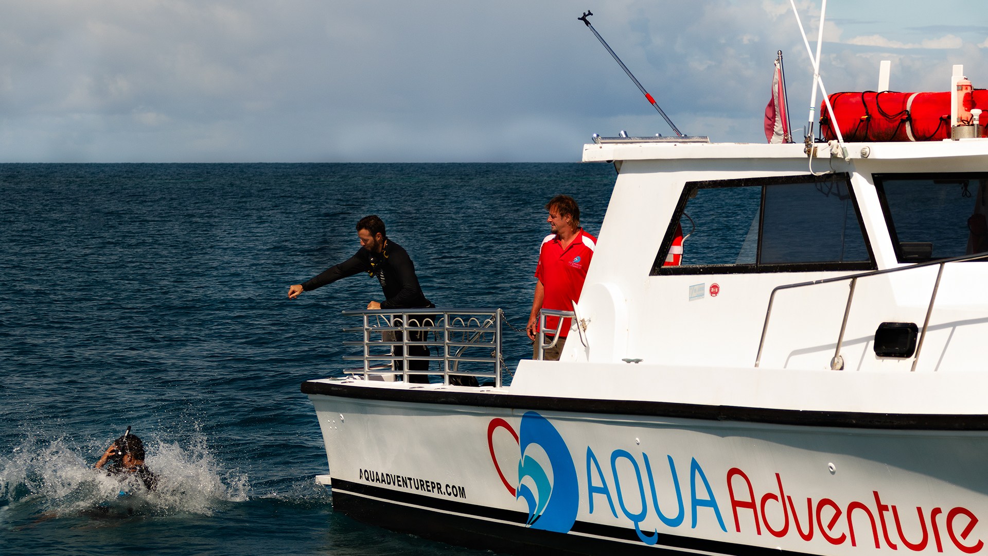 Scuba diver jumping into water from boat
