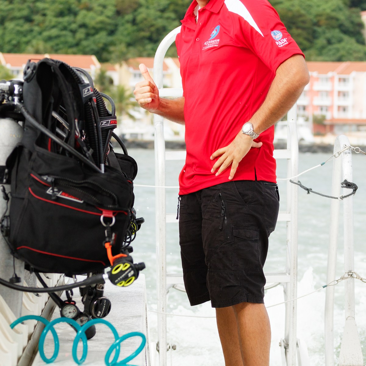 Scuba instructor showing scuba diving equipment