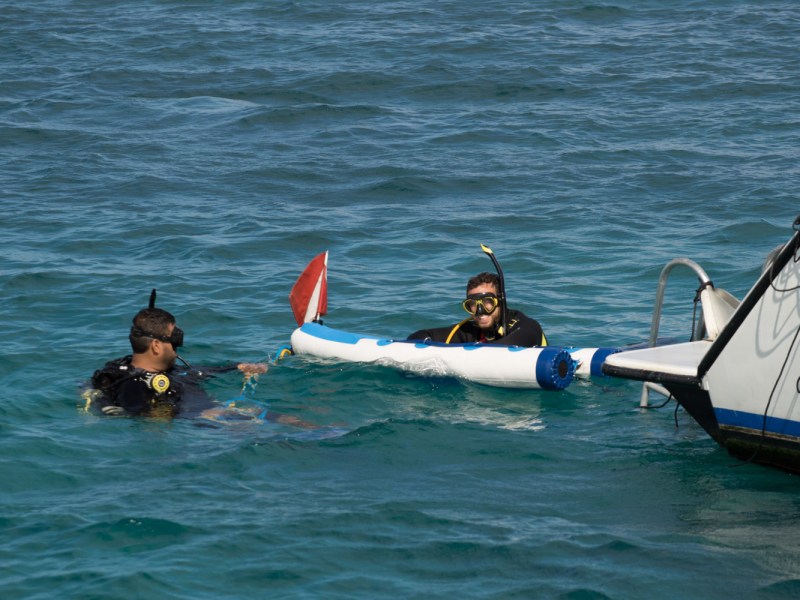 scuba divers and raft
