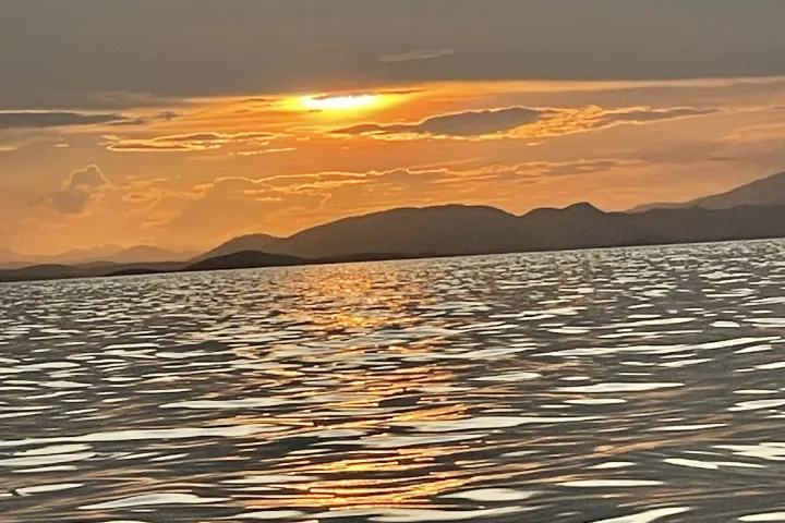 a sunset over a body of water